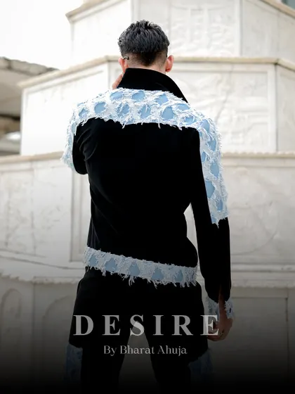 The back view of the denim patchwork jacket, showing the western-style yoke and the continuation of the distressed denim panels.