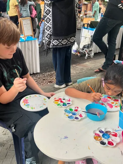 Our art tables are a place for everyone. Here, kids of different ages sit side by side, lost in the simple joy of painting.