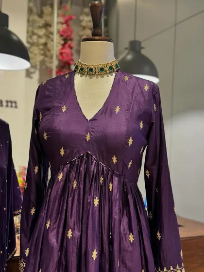 Royal purple is always a statement. This anarkali is adorned with delicate gold buttis, offering a look of regal elegance.