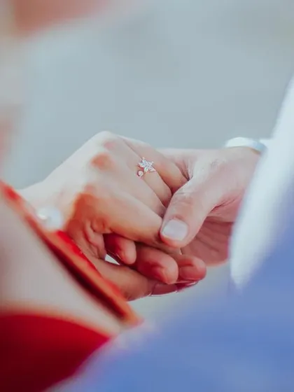 A detail shot of the couple holding hands during their pre-wedding session. This simple, symbolic gesture of connection and promise is a powerful part of their love story.