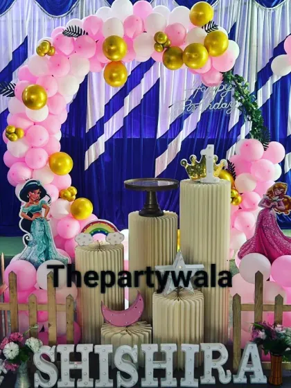 A pink and gold princess theme with a striped blue and white backdrop, creating a unique and fun look.