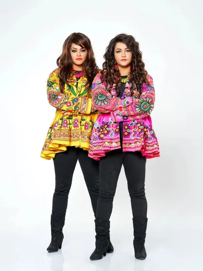 Our style is a reflection of our music: vibrant, traditional, and full of life. We carefully select our outfits for every performance, like these colorful jackets, to match the festive mood and celebrate our culture.