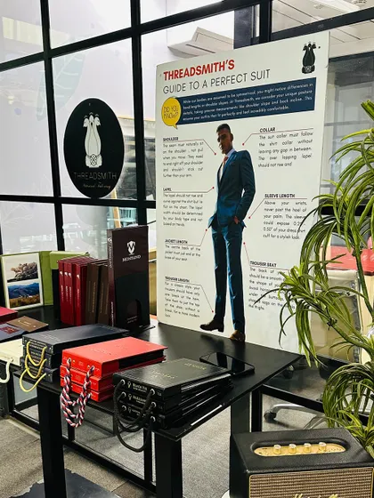 Our educational "Guide to a Perfect Suit" poster on display at the KPMG trunk show. We aim to demystify the bespoke process, providing clear information on everything from shoulder fit to trouser break, helping clients appreciate the nuances of a well-made suit.