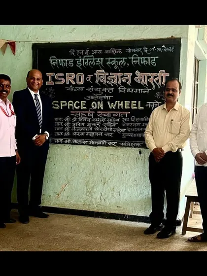 Standing with fellow educators in front of my welcome art for the ISRO 'Space on Wheel' event. Such collaborations help bridge the gap between art and science for students.