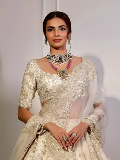 For the bride who believes more is magnificent, I present this double-stacked masterpiece. It layers a handcrafted emerald, diamond, and pearl choker with a rose-pink necklace and a bold emerald pendant.