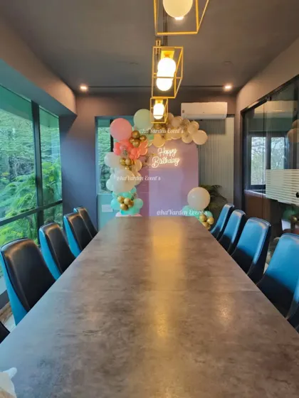 A small, tasteful balloon decoration in a corporate meeting room. This shows how I can add a festive touch to any space, big or small.