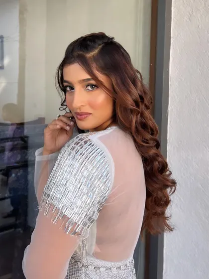 A beautiful side profile of the Tomorrowland-inspired look. The soft curls and shimmering makeup create a magical and futuristic vibe.