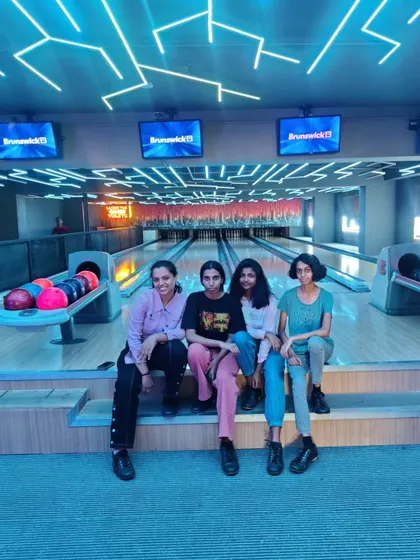 A group of girls sitting at our bowling alley, ready to play.