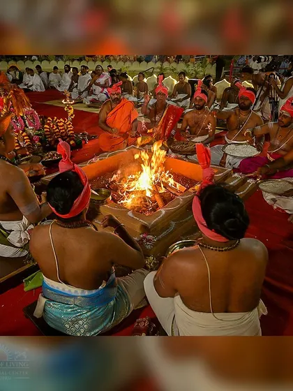 Priests gathered around the sacred homa kunda (fire pit) during the Maha Rudra Homa at night. The fire, the chants, and the collective intention create a transformative experience.