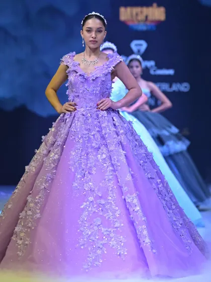 The power pose. This lavender ball gown from my GULFAM collection commands attention with its structured off-shoulder neckline and intricate floral details.