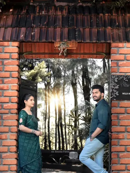 A stylish portrait of the couple at a resort entrance, showing how we use architectural elements to frame our shots.