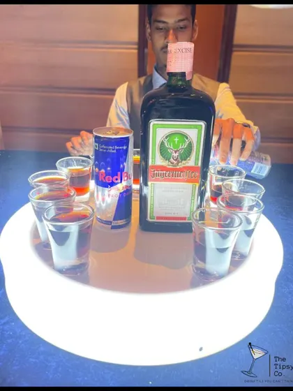 A tray of Jagerbombs being prepared. The glowing tray and the iconic combination of Jagermeister and Red Bull make this a guaranteed party-starter.