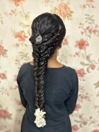 A slightly different angle of the fishtail braid, showing the texture and clean sections that are essential for a professional look.
