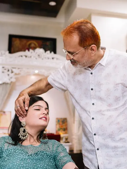 A father's blessing during his daughter's mehendi ceremony. This is a beautiful, tender moment between Disha and her dad.