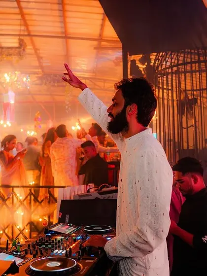 The whole club was lit up with festive lights for Diwali. I'm raising a hand to the energetic crowd.