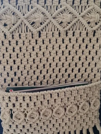 This macrame wall pocket is both beautiful and practical. The intricate diamond and net pattern creates a sturdy holder for magazines, mail, or even a small tablet.
