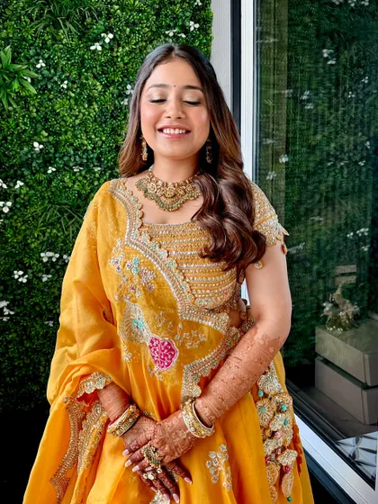 A happy, smiling shot of the HaathDaan look. The glowing skin and soft makeup let her natural joy shine through.