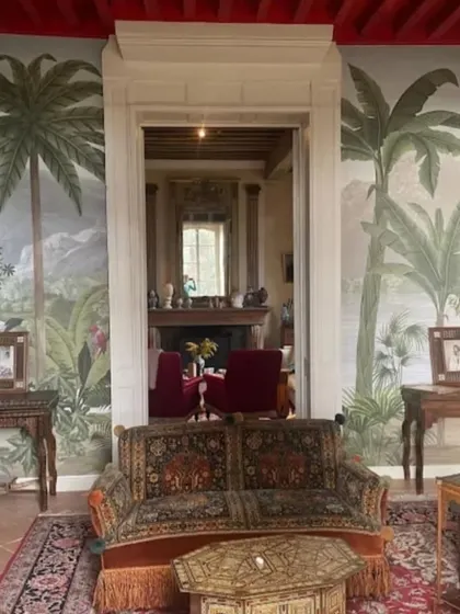 A grand, vintage-style tropical mural in a large hall, creating a sense of old-world colonial charm and elegance.
