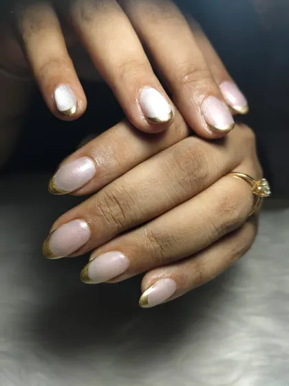 A modern twist on a classic. This look features a clean, natural base with a striking gold chrome French tip. It's an elegant and sophisticated design that shows how a small detail can make a huge impact, perfect for when you want your nails to look effortlessly chic.