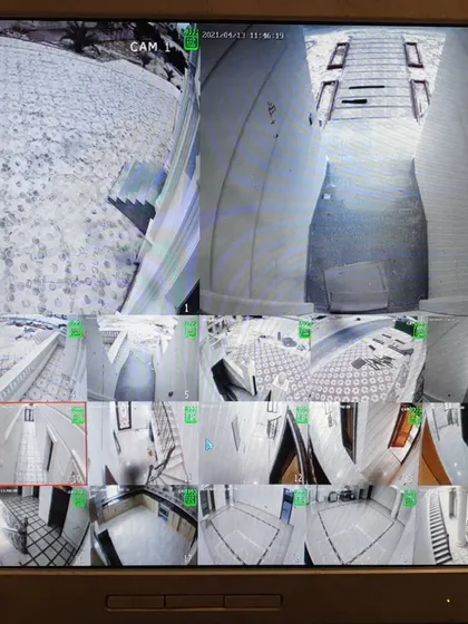 An identical view of the multi-camera display. You can see both indoor and outdoor areas, including hallways, rooms, and rooftops.