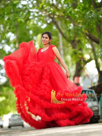 A joyful shot in the red ruffled gown, capturing its playful and dramatic movement.