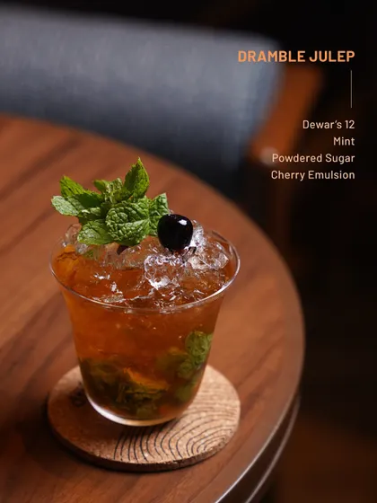 The Dramble Julep, a refreshing blend of mint, cherry, and powdered sugar. An easy-sipping classic.
