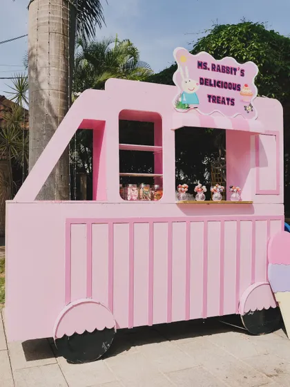 "Ms. Rabbit's Delicious Treats," a custom-made pink truck prop for serving snacks at the Peppa Pig party.