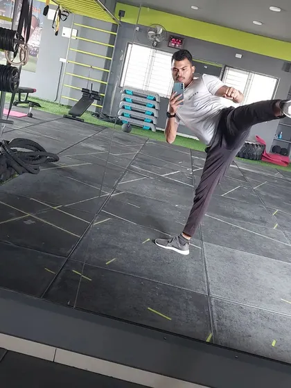 A demonstration of a high kick, showcasing the flexibility and power we build in my cardio kickboxing workouts. This is a great way to improve coordination and build confidence.