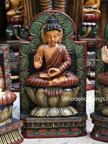 A close-up of another seated Buddha, this one with a red and green color scheme, highlighting the fine painting work.