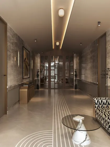 From another angle, the hallway reveals its length and the careful placement of furniture and lighting. The linear floor pattern guides the eye, while a patterned settee and a sculptural side table create a stylish resting point.