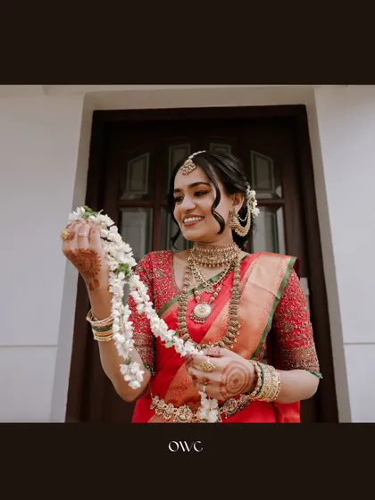 A beautiful portrait of the bride holding a string of jasmine flowers.