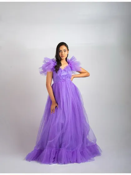 A full-length shot of the lavender ruffled sleeve gown, showing its voluminous skirt and elegant silhouette.