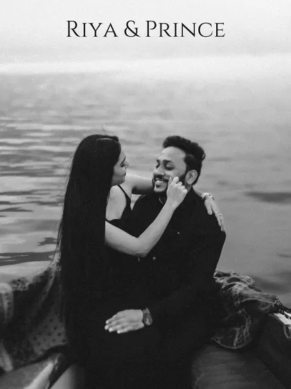 A timeless black and white portrait of a couple sharing a tender moment on a boat, full of classic romance.