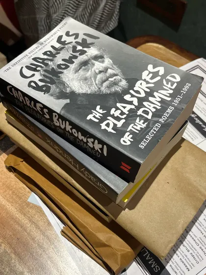 Books ready for our book swap social. Everyone brings a wrapped book, and the mystery of what you'll go home with adds a fun element to the event.