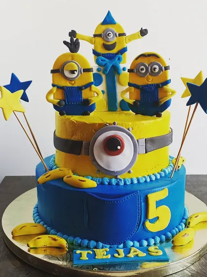 A fun and mischievous Minions cake, with three handcrafted minions celebrating a 5th birthday.