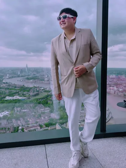 Another pose against the London skyline, showing how a well-fitted blazer can create a sharp silhouette.