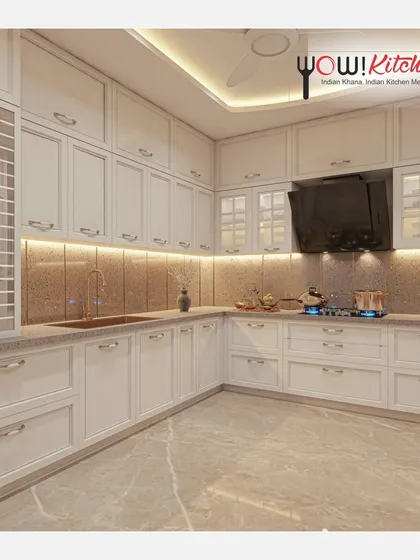 Another perspective of the timeless white kitchen, showcasing the ample storage and the warm glow of the under-cabinet lighting on the textured backsplash.