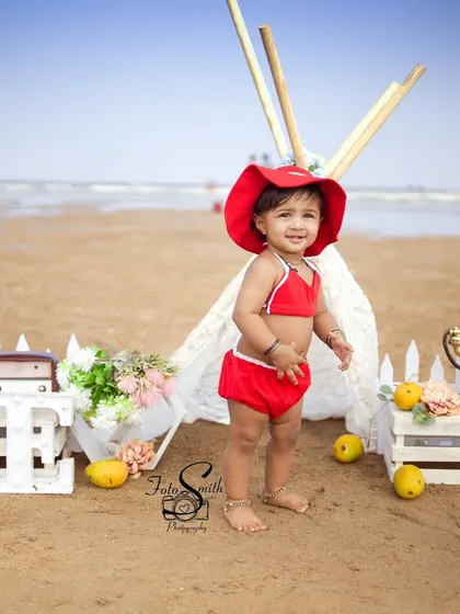 This little beachgoer in her bright red swimsuit is all smiles for her first birthday. I love using natural settings like the beach to create relaxed and authentic portraits.