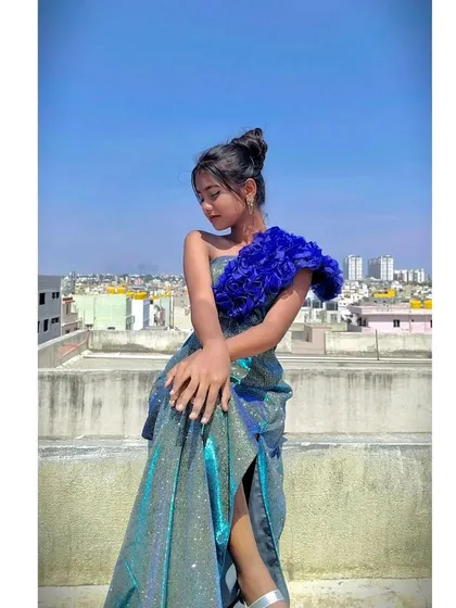 A different pose showing the versatility and modern style of this rooftop-ready gown.
