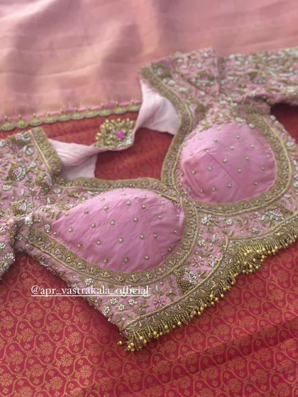 A pink blouse with padded cups and all-over floral embroidery.