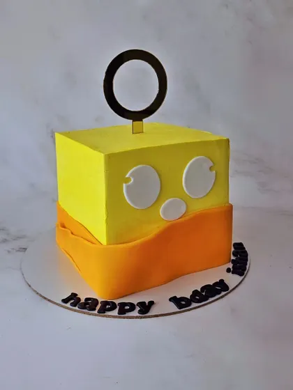 A Roblox-themed cake for a true gamer. This square cake is designed to look like the Fruit Buddha character from the popular online game.