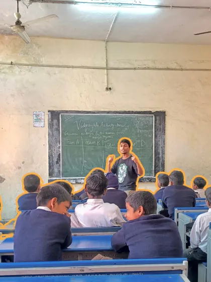A fellow leads an interactive game with students in a classroom. We use gamification to teach complex ideas, making learning feel like play and improving student engagement and retention.