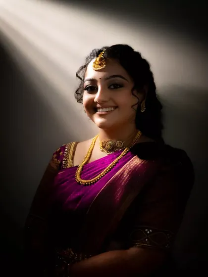 A beautiful portrait of a bride illuminated by a single ray of light. The dramatic contrast between light and shadow creates a powerful and angelic effect.