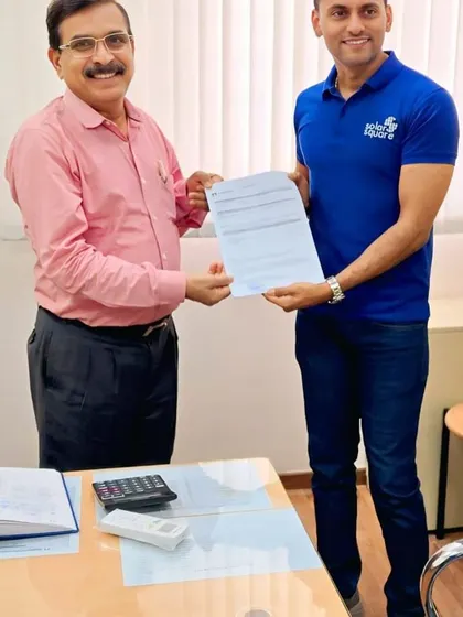 A formal handshake between our representative and a society chairman, sealing the deal for a greener future.