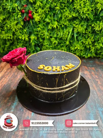 A sophisticated black cake with gold splatter, topped with a single red rose. This minimalist yet striking design is perfect for a modern and stylish celebration for Soham.