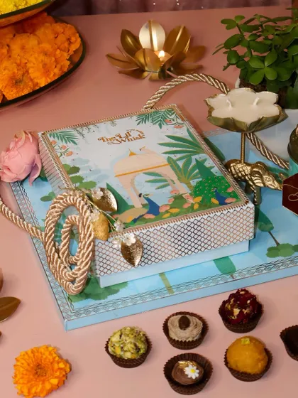 The Gardenia Platter, beautifully arranged with our Peacock Paradise sweets box, a candle, and a jade plant. It's a thoughtful and sustainable gift that keeps on giving.