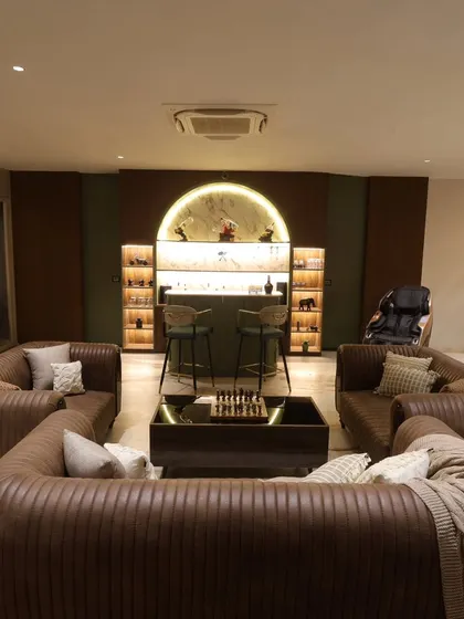 A home bar should be the heart of the evening. In this Delhi home, I designed an inviting bar area with a backlit stone-look display, a sleek PU-finished counter, and cozy, customized sofas perfect for long conversations and relaxation.