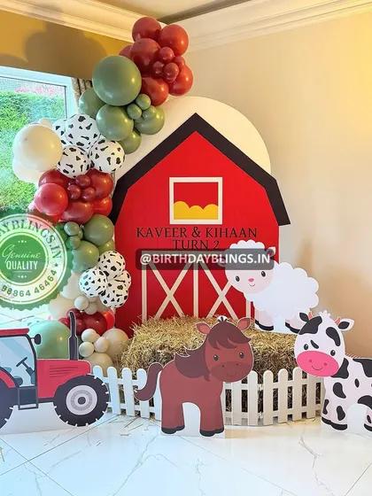 A fun and colorful farm animal theme, complete with a red barn backdrop, hay bale, and cute cutouts of a horse, cow, and sheep. The tractor cutout adds a great touch for little vehicle lovers.