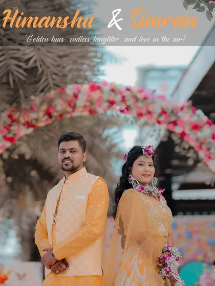 A classic Haldi portrait of the couple standing under a beautiful floral arch. Their coordinated yellow outfits and the vibrant decor create a picture-perfect moment.
