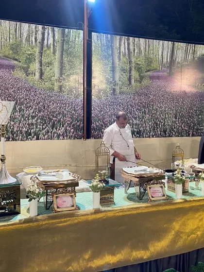 A live counter set against a beautiful backdrop of a forest mural, blending nature-inspired decor with culinary action.
